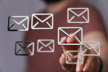 Poster - Close-up of a hand selecting an email icon, representing digital communication and email marketing.