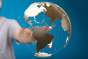 Poster - Person interacts with a digital globe, symbolizing global reach and connectivity.