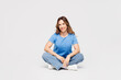 © ViDi Studio - Full body young smiling happy cheerful fun Caucasian woman wears blue t-shirt casual clothes sit looking camera isolated on plain solid white color wall background studio portrait. Lifestyle concept.