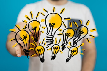 Poster - Hand interacting with glowing lightbulbs,creative ideas, solutions, innovation, and brainstorming concept.