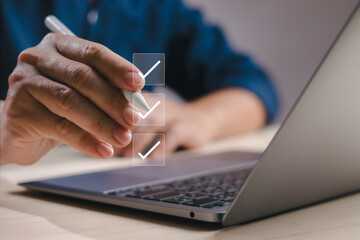 Poster - Businessman working with computer using pen to check boxes, fill out online survey or checklist and approve digital documents with virtual screen. Assessment and document management concept.