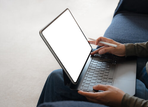 Businesswoman hand holding stylus pen working on digital tablet with white blank touch screen,Close up freelance designing on computer graphic tablet with electronic pen during working online at home

