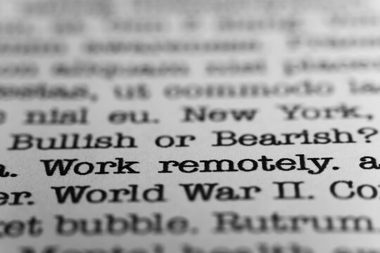 Work remotely. Text printed on a page. A piece of paper with a phrase written in retro typewriter font