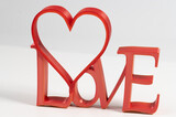 3d red heart with the inscription love on a white background isolated. Red inscription love