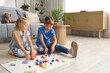 © Pixel-Shot - Little children sculpting from plasticine on floor at home