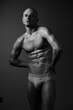 © SHOTPRIME STUDIO - Black and white image of a muscular man posing confidently, showcasing strong physique and expression. The composition emphasizes fitness and strength.