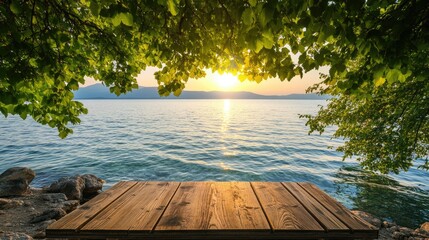Poster - A rustic wooden table set beneath leafy branches overlooking a tranquil lake at sunset, creating a peaceful and inviting natural scene