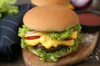 © New Africa - Tasty cheeseburger with sauce on table, closeup