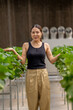 © ultramansk - A woman enjoys picking fresh strawberries in a modern greenhouse. Sustainable farming ensures high-quality, organic fruit production for healthy eating and eco friendly agriculture practices.