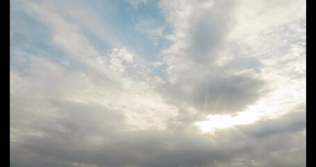 Wall Mural - beautiful fluffy cumulus clouds in a bright blue sky on a clear summer day. sun rays shine through, 