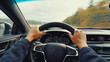 © Audtakorn - Steering Wheel Drive: The driver's focused hands grip the steering wheel with determined strength, navigating a blurred, sunlit highway, capturing a dynamic perspective on a solo journey.