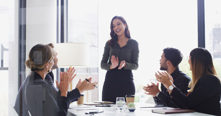 Poster - Colleagues, applause and praise for speaker, boardroom and woman with smile for proposal or success. Happy, people and clapping for celebration in meeting, achievement and motivation for sales pitch