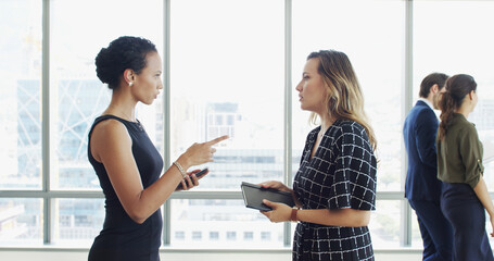 Poster - Business women, discussion or meeting with notebook by window for corporate development or growth. Female people, employee or colleague with company proposal on improvement or delegation at workplace