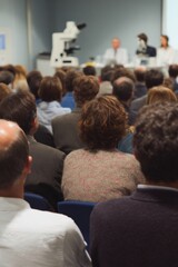 Poster - Diverse Audience Attending Scientific Panel Discussion with Keynote Speakers on Stage, Professional Business Attire in Modern Conference Setting