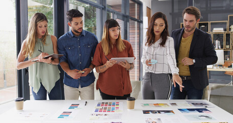 Poster - Group, creative business people and discussion in meeting for brand strategist with tablet. Team, manager and collaboration in startup office for planning, proposal and choice for ad campaign design