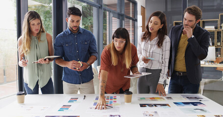 Poster - Team, creative business people and discussion with paper for brand strategist with tablet. Group, manager or collaboration in startup office for planning, brainstorming or idea for ad campaign design
