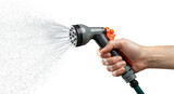 Hand holding a garden hose nozzle spraying water for irrigation