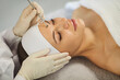 © Studio Romantic - Cosmetologist, dermatologist beautician performing female face forehead care using derma tool, facial deep cleansing, skincare instrument professional treatments, happy woman enjoying to improve