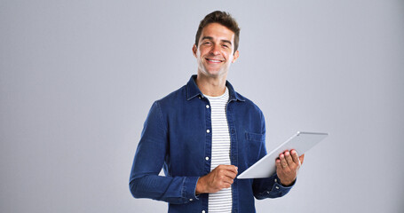 Leinwandbilder - Tablet, model and smile with portrait in studio for social media, internet and website app. Happy, man and isolated on white background with technology for digital networking, e book or research