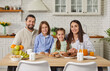 © Studio Romantic - Portrait of happy family with children enjoying holiday dinner on kitchen at home, sitting together for lunch in a cozy setting filled with warmth and connection every day with love.