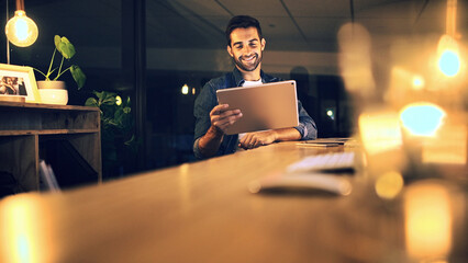 Fototapete - Night, business and man in office, tablet and smile with graphic designer, internet and web proposal. Person , evening and employee in workplace, tech and app for creative project and online reading