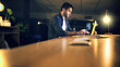 © peopleimages.com - Desk, laptop and night with business man in office for deadline or feedback on creative report. Computer, research and typing with design employee in dark workplace for productivity at zero hour