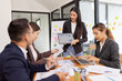 © SOMKID - Group of Asian business working with analysis project brainstorm in modern office, Asian businesspeople team working together, Business startup and company strategy planning concept.