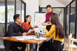 © SOMKID - Group of Asian business people working together and presentation a meeting in office,