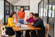 © SOMKID - Group of Asian business people working together and presentation a meeting in office,