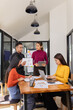 © SOMKID - Group of Asian business people working together to presentation with dashboard analysis data management a meeting table in office, Business investment metrics or planning concept.