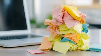 Aufkleber - Many colorful crumpled sticky notes stacked on office desk with laptop in background, symbolizing work overload, stress, and mess in business