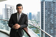 © Jack Tamrong - Handsome businessman standing in high rise office balcony