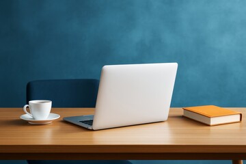 Poster - Modern workspace with laptop, coffee cup, and book on wooden desk against stylish blue background in soft light for creative business concepts.