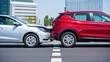 © olgakris - Two modern cars involved in rear-end collision on city street with visible vehicle damage