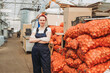 © ADDICTIVE STOCK - Greenhouse worker managing onion cultivation process
