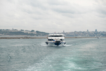 Aufkleber - Cruising through the Bosphorus Strait with city views on a cloudy day