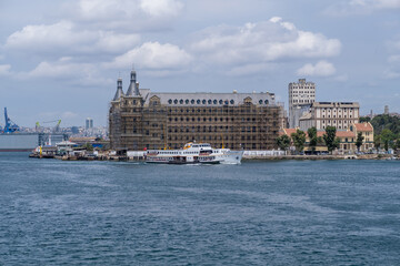Aufkleber - Bosphorus waterfront with restoration work on historical buildings and a ferry cruising in sunny weather