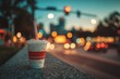 © DigitalFrame - Paper soda cup with red stripe and straw in city lights
