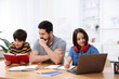 © New Africa - Father helping his kids with homework at wooden table indoors