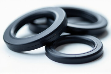 Poster - A collection of black rubber rings lying flat on a white background, perfect for illustration and design purposes