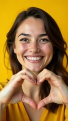 Aufkleber - A woman forms a heart shape with her hands, conveying love and affection