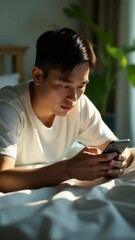 Aufkleber - A person relaxing in bed with their smartphone, possibly checking notifications or watching videos
