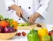 © nana - Chef's hands cutting vegetable and other vegetables and fruits, in the kitchen