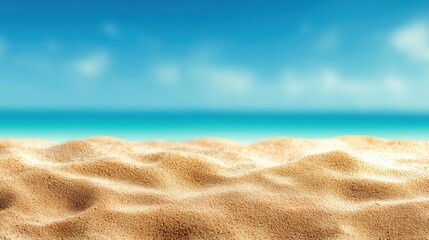 Poster - Fine golden sand creates a beautiful textured foreground against a blurred backdrop of turquoise ocean and clear sky