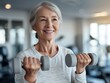 © hakule - A woman is smiling while holding two dumbbells