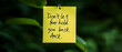© Slamet - Motivational Note On Yellow Sticky Note With Green Background