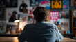 © Curioso.Photography - Creative man sitting and contemplating inspiration wall filled with art and design posters.