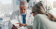 © peopleimages.com - Doctor, man and woman with document for medical aid, life insurance or application in clinic. People, healthcare employee and clipboard with form, survey or paperwork for registration or service