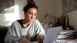 © Kevin - College Student Attending Virtual Lecture from Small Bedroom Desk