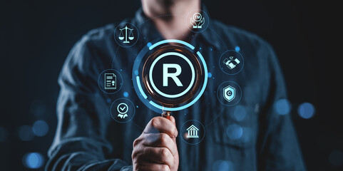 Poster - Trademark protection concept with magnifying glass and legal icons on dark background.